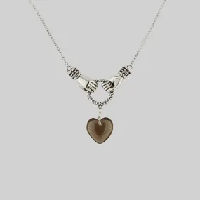 UNITE. Hand Grasping Smoke-Black Glass Heart Necklace - Silver